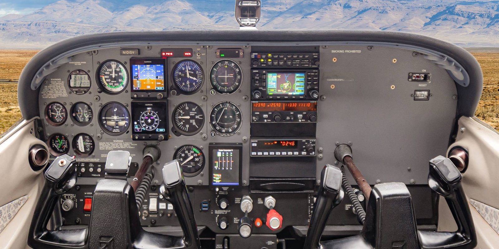 Cessna cockpit and instrument panel with Idaho mountains through the windshield at Carmel Aviation in Boise