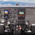 Cessna cockpit and instrument panel with Idaho mountains through the windshield at Carmel Aviation in Boise